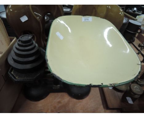 A set of vintage cast kitchen scales and weights with enamel plate
