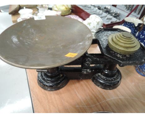 A set of vintage cast balance scales with brass cast weights