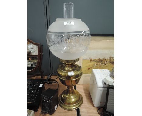A vintage brass bodied oil lamp