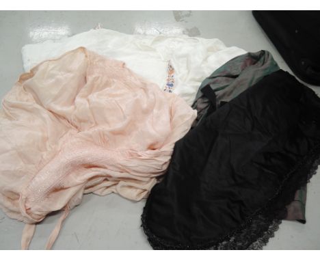 Four items of vintage ladies clothing including a peach 1940s St Michaels nightdress, an iridescent green taffeta skirt aroun