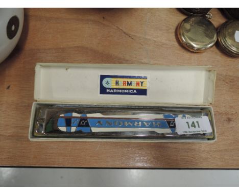 A vintage Harmony coloured harmonica, in original box