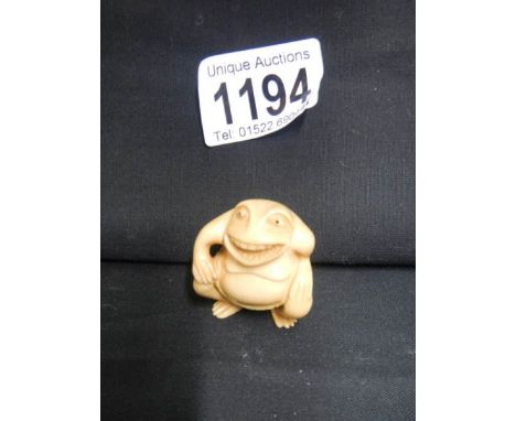 A signed ivory netsuke of a frog