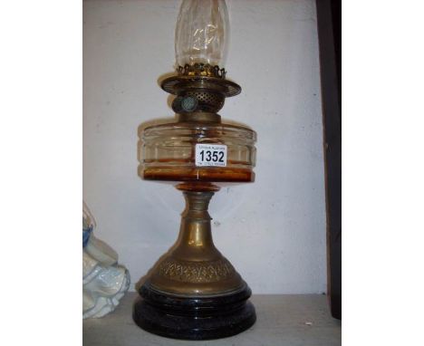 An oil lamp on pot base with brass column and glass font