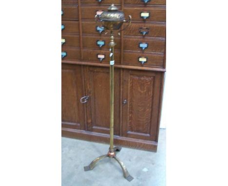 A brass floor standing oil lamp