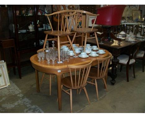 A set of 6 Ercol dining chairs and a suitable extending dining table