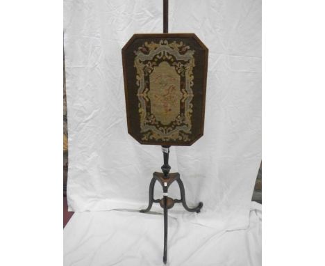 A period pole screen with tapestry inset