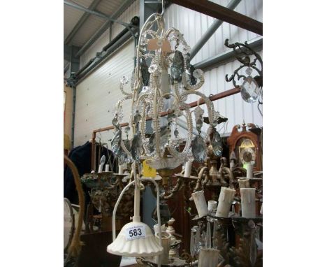 A single lamp ceiling light with glass droppers