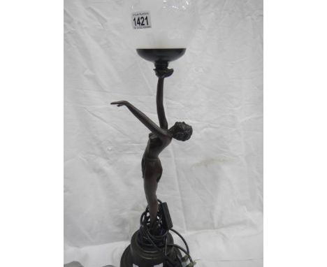 A table lamp with naked lady figure