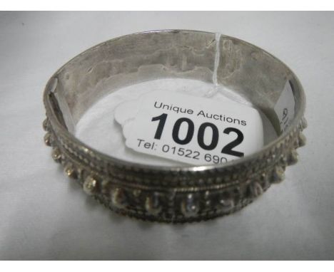 A middle eastern white metal slave bangle