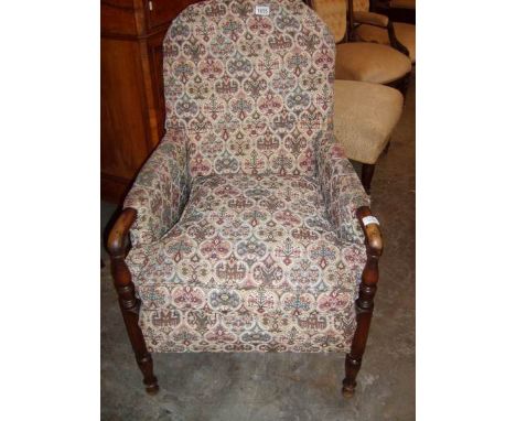 An Edwardian arm chair with tapestry upholstery