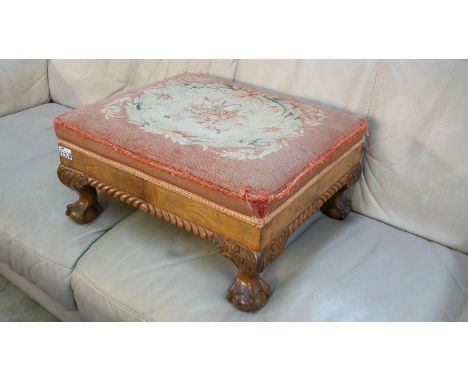 A footstool with tapestry cover