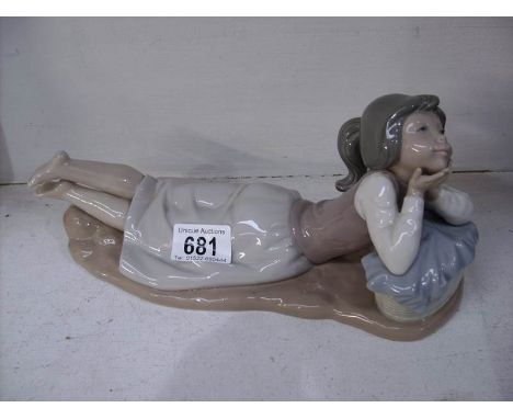 A NAO figure of a reclining girl
 
Good condition
Requires some cleaning but otherwise fine