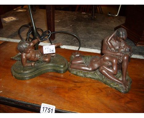 A table lamp on resin cherub base and a resin figure of romantic couple