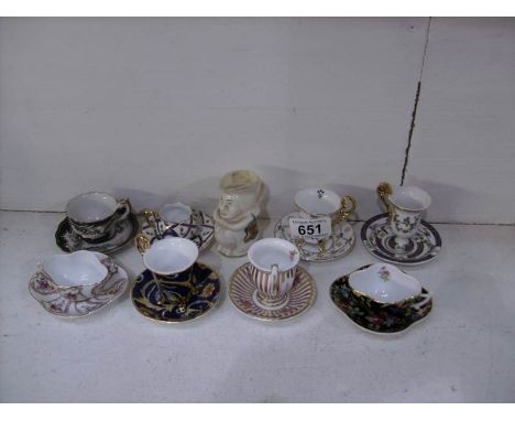 8 miniature cups and saucers and a Carlton ware crested  Toby jug