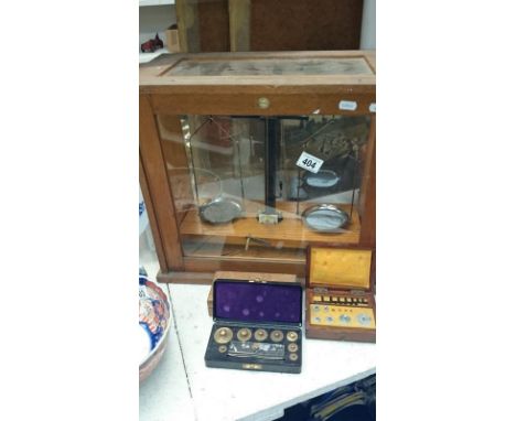 A cased set of laboratory scales and weights