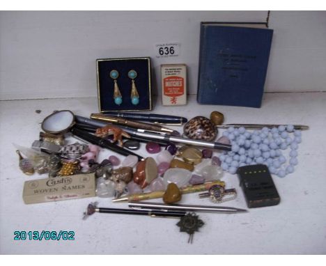 An interesting box of miscellaneous items including pens, lighter, stones, curios, jewellery etc