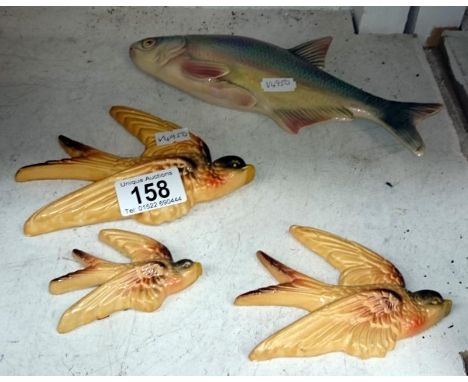 A set of 3 pottery flying ducks and a Dutch ceramic fish