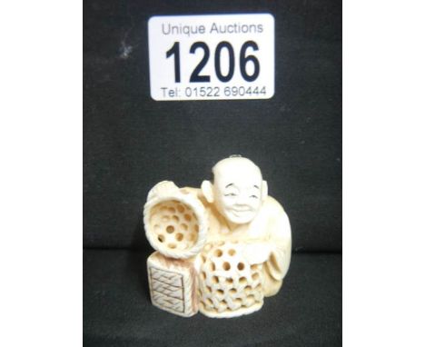 A signed ivory netsuke of a basket maker