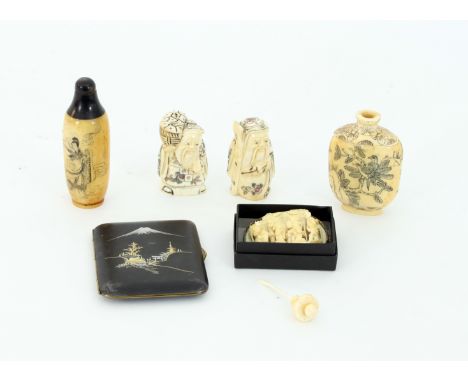 A Cantonese carved ivory brooch depicting figures in an interior, 5cm wide, two Japanese bone netsuke, two Japanese bone snuf