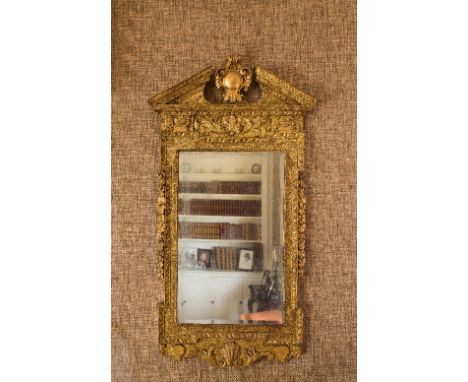 A George II carved gilt gesso wall mirror with broken arch pediment and leaf carved frieze with oak leaf swag and shell carve