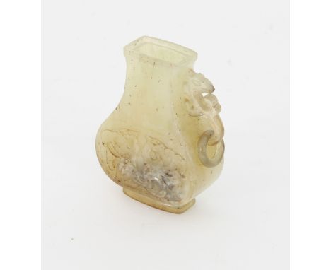 A Chinese jade vase, Qing dynasty, of pear shape with phoenix mask and ring handle to one side, cover and one handle missing,