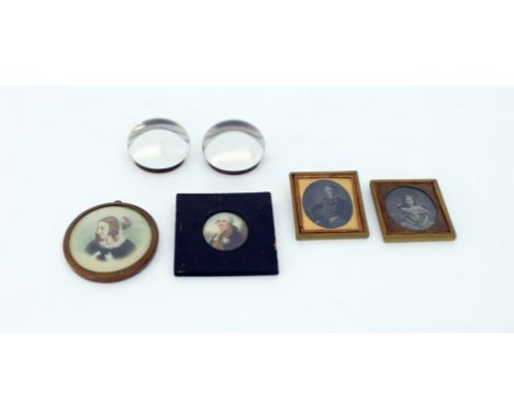 A pair of Victorian glass paperweights, each backed with a printed and painted portrait, Queen Victoria and Prince Albert, a 