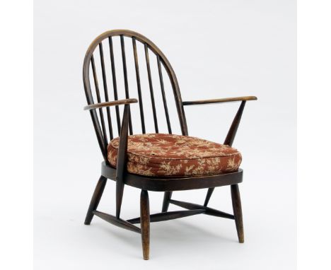 An Ercol open armchair, on turned supports united by an H stretcher