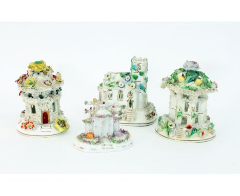 Three Staffordshire porcellaneous flower encrusted pastille burners, circa 1840, one modelled as a church, two as pavilions a