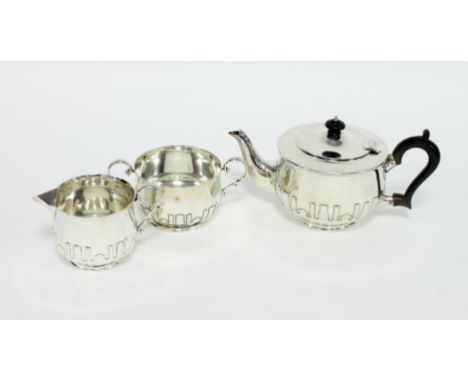 A silver three-piece tea set, Charles Edwards, London 1912, decorated with cut card work, approximately 1010gm