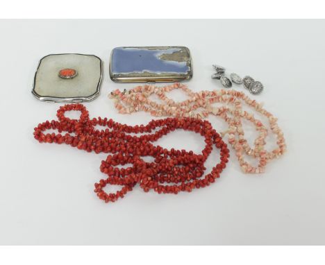 A silver compact with carved oval coral panel to the centre, 7cm wide, two coral necklaces, six silver buttons and an enamell
