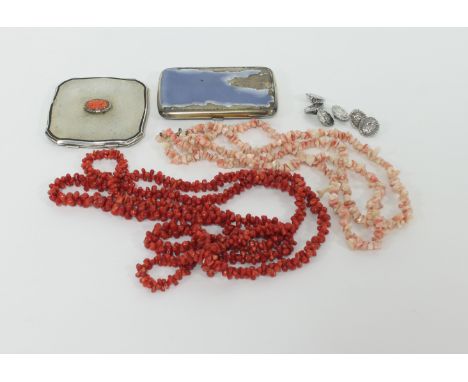 A silver compact with carved oval coral panel to the centre, 7cm wide, two coral necklaces, six silver buttons and an enamell