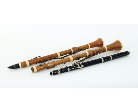 A Goulding and Co boxwood and ivory clarinet, another similar and an ebony flute by Harris and Son, London 