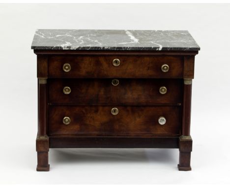 A mahogany Empire commode, circa 1810, the green marble top above three graduating drawers within turned pilasters on block f