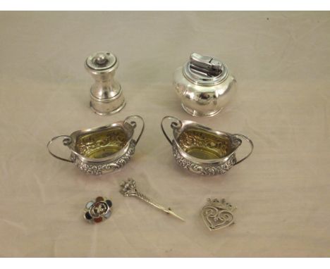 A pair of late Victorian silver salts with gilt-washed interior and twin handles embossed with foliate and scrolling decorati