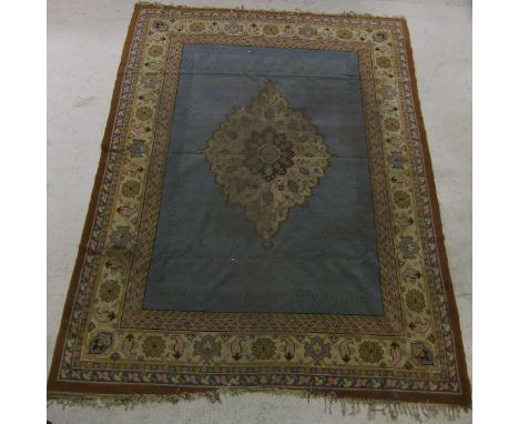 A Caucasian carpet, the central cream, pink, mustard, green and brown medallion on a mid blue ground within cream, pink, must