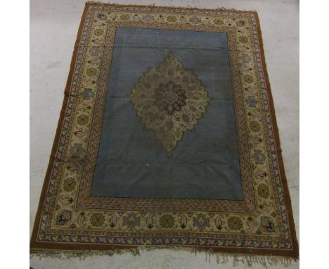 A Caucasian carpet, the central cream, pink, mustard, green and brown medallion on a mid blue ground within cream, pink, must