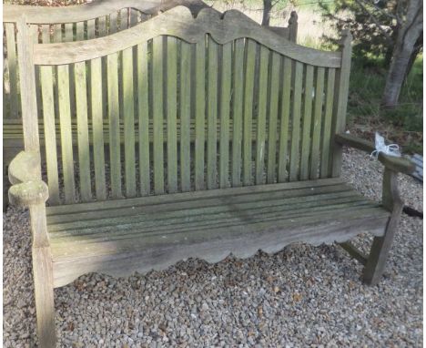 A modern teak high back bench with candle flame style finials  CONDITION REPORTS Approx 200cm wide x 121cm high.  Weathering,