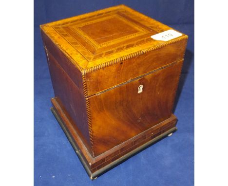 An early 19th Century mahogany and inlaid single section tea caddy with zinc lined interior on a brickwork style plinth base 