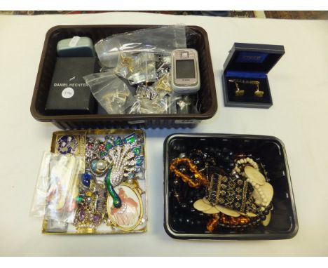 Three boxes of assorted costume jewellery to include watches, buttons, brooches, necklaces, cufflinks, etc