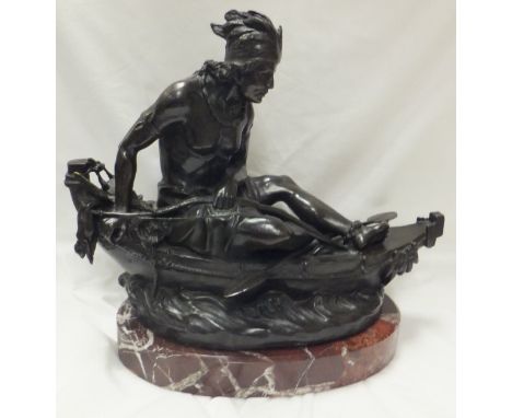 AFTER DUCHOISELLE "North American Indian hunter sitting in a canoe with bow, holding dead game", bronze, on red marble base C