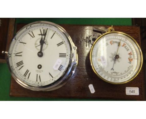 A wall mounted Smiths Astral ship's style wall clock with an associated brass cased aneroid barometer thermometer