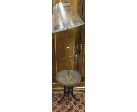A standard lamp in the 19th Century manner, the painted simulated marquetry inlaid shade on a plain painted metal support to 