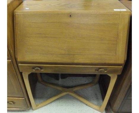 An Ercol elm and beech bureau, the sloping fall enclosing a pigeon holed interior over a single drawer on chamfered supports 