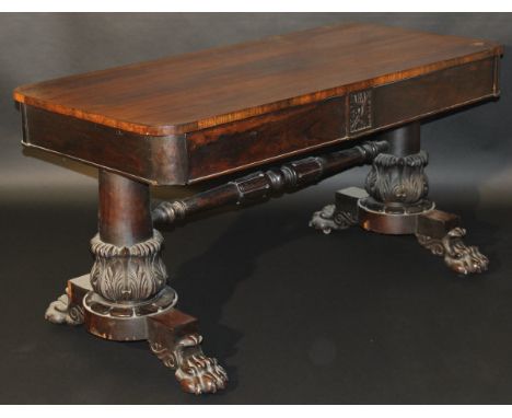 A 19th Century rosewood library table with two frieze drawers raised on acanthus carved column united by turned and tulip car