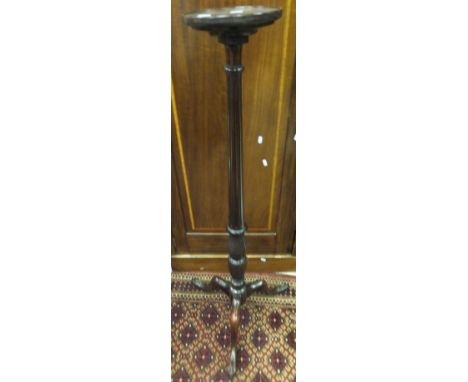 A reproduction mahogany torchere stand raised on tripod base