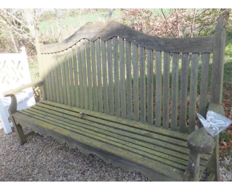A modern teak high back bench with candle flame style finials  CONDITION REPORTS Approx 235cm wide x 126cm high.  Weathering,