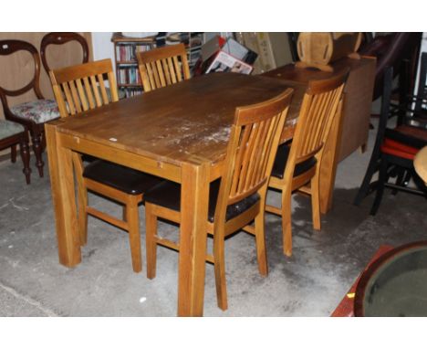 A modern light oak dining table and four chairs. 75 cm x 140 cm x 90 cm. CONDITION REPORT: Some minor scratches, water marks,