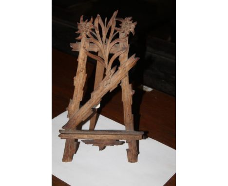 A 19th century continental carved soft wood easel stand, of small proportions, carved naturalisticly with log effect and foli