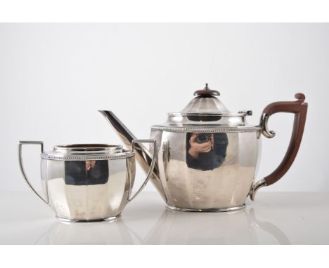 Silver three piece tea set, polygonal form, beaded border, teapot with composition handle and finial, milk jug and sugar bowl