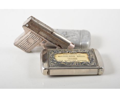 Five novelty vesta cases, an engine turned silver case with wheel to side, a hunting scene case with the Compliments of Nicho